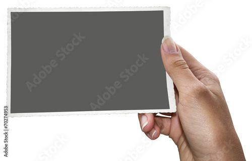 A woman holding an old black and white photo with clipping path for the inside