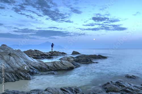 Fisherman on the rocks at dusk