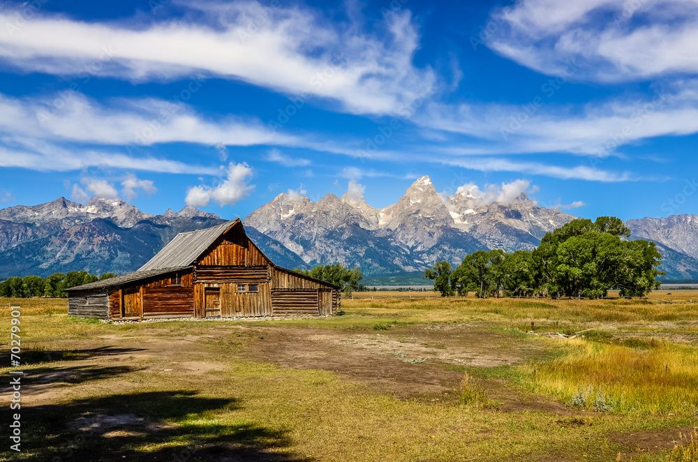 Scenic view of Grand Teton with old wooden farm