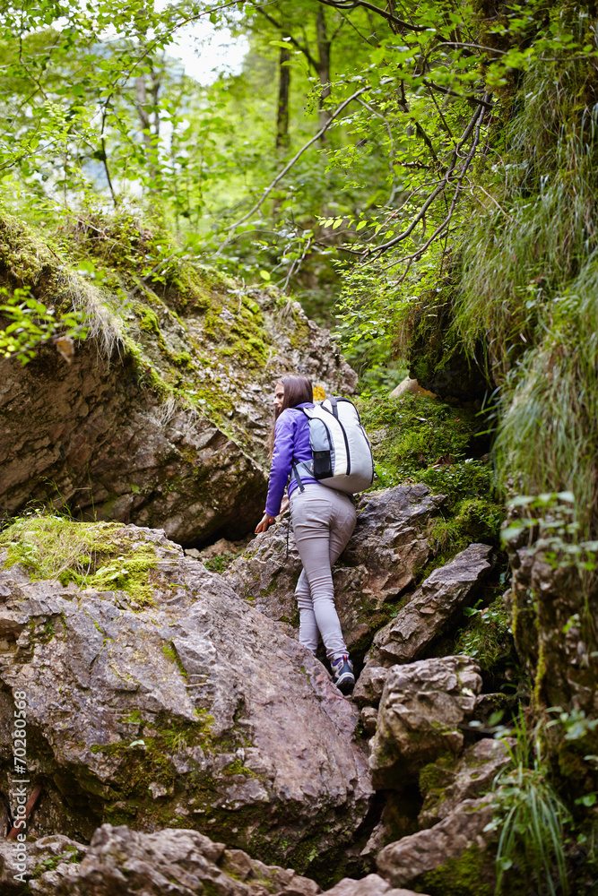 Hiker lady with backpack on trail Hiker lady with backpack on trail