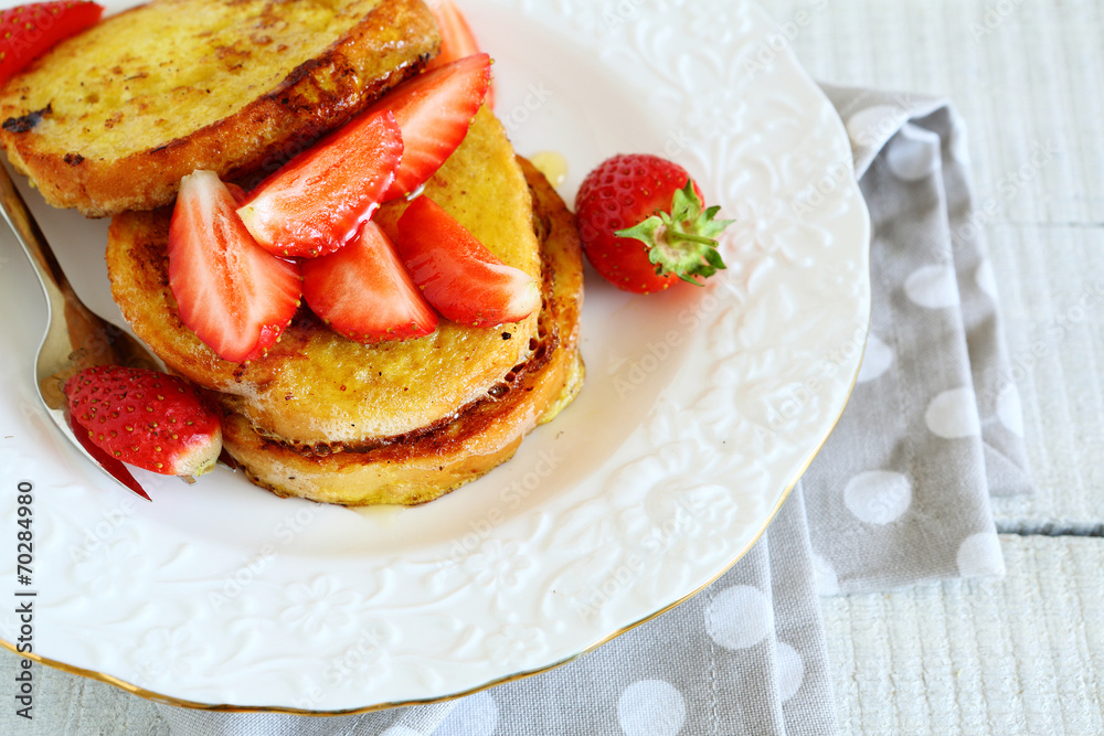 stack of toast with honey and strawberries