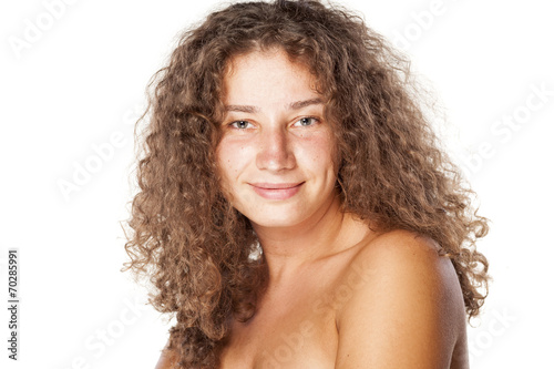 smiling young woman without make-up and curly hair
