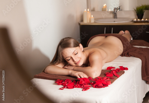 Woman enjoying Ayurveda oil massage in spa photo
