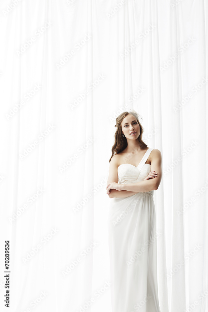 Young bride in wedding dress, studio shot . Young bride in wedding dress, studio shot .