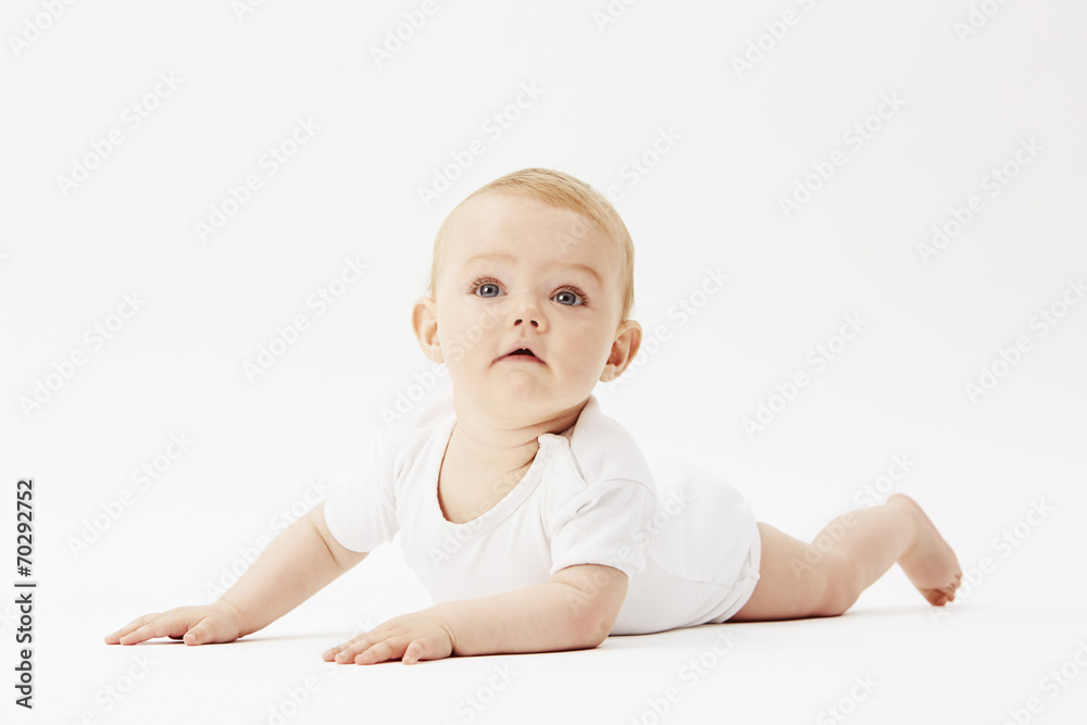 Young baby girl crawling on front, studio. Young baby girl crawling on front, studio.
