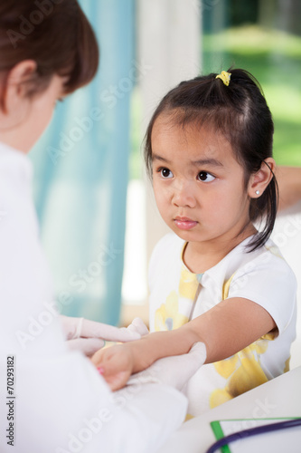 Scared asian girl before vaccine