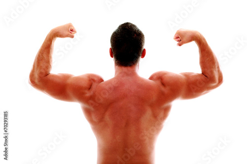 Rear view of young muscular man showing his biceps