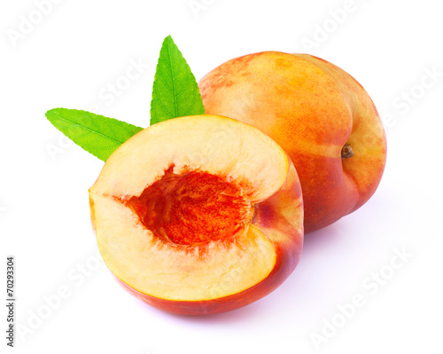 Ripe peach with leaf.