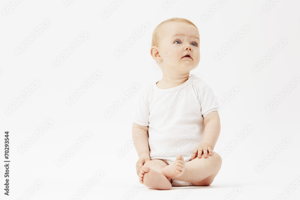 Young baby girl looking up, studio. Young baby girl looking up, studio.