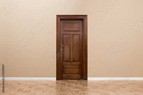 Wooden door in the empty room with copy space