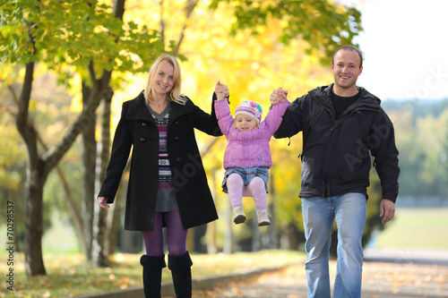 The happy family walks on autumn park