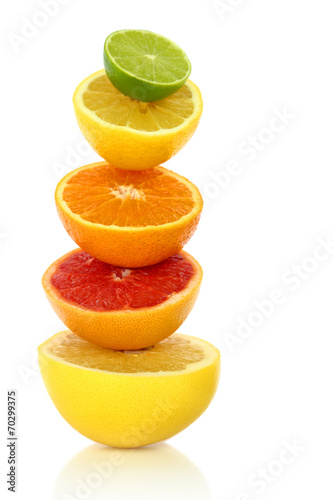 Fresh citrus fruit in a row on white background