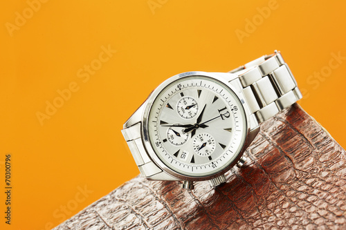 Luxury men's watch against colored background .