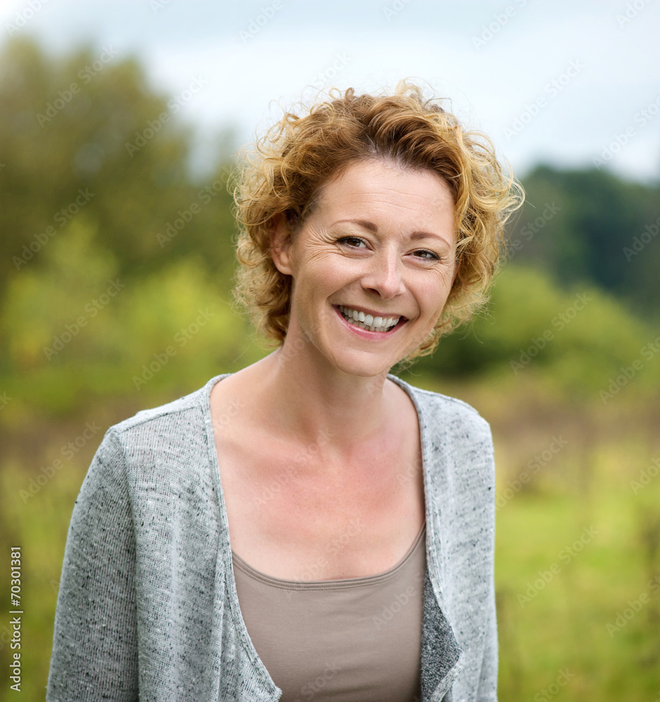 Beautiful mature woman smiling in the park Beautiful mature woman smiling in the park