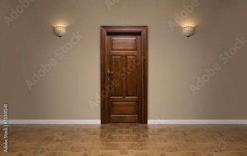Closed wooden door in the empty room with copy space photo
