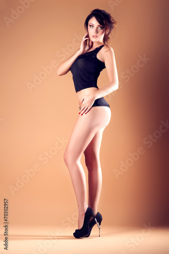 Sexy brunette woman posing in studio