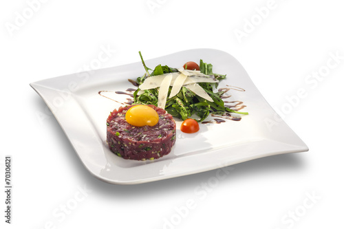 Delicious Steak tartar with yolk and rocket salad ready to serve