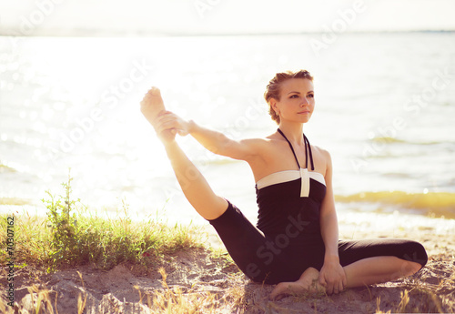 Beautiful sporty woman is working out on the river side