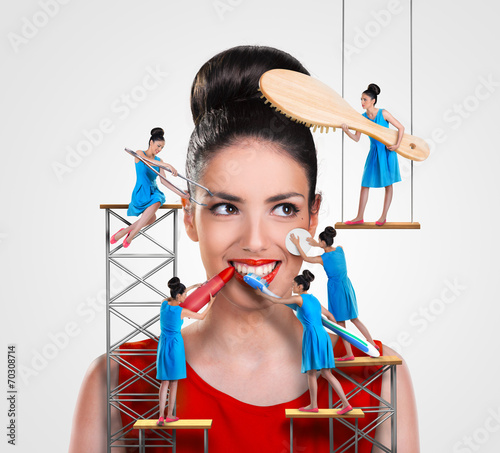 Small workers working on a beautiful woman