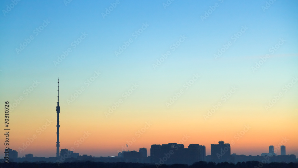 clear blue and yellow dawning sky over city