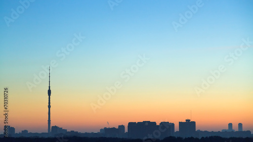 clear blue and yellow dawning sky over city