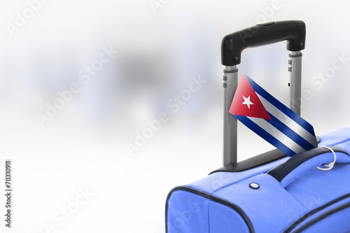 Photography Destination Cuba. Blue suitcase with flag.
