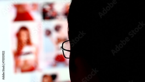 Man watching pictures of nude women in internet