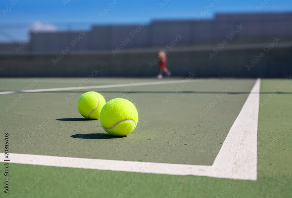 two tennis ball near baseline