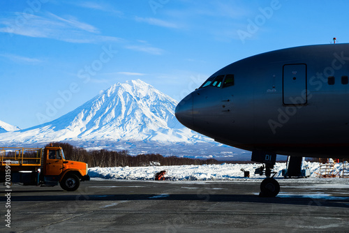 Loader pulls up to the plane on the tarmac