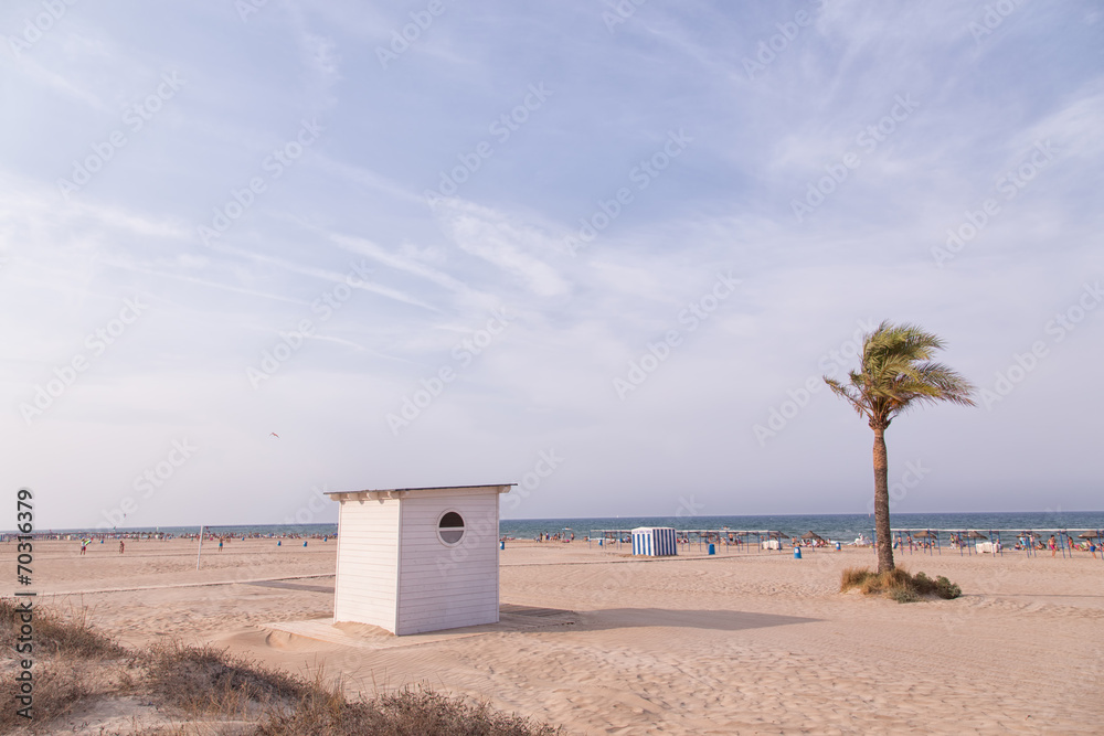 Gandia, SPAIN - JULY 27 2014: People sunbathing on the beach of