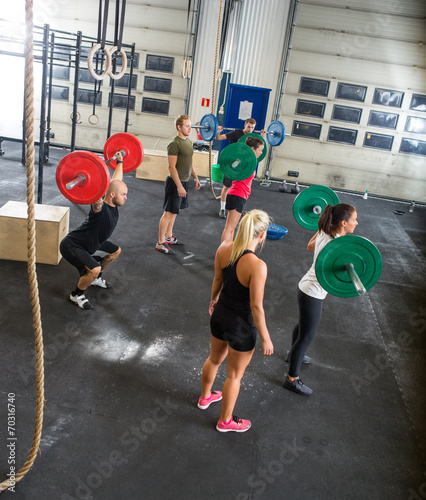 Trainers And Athletes In Weightlifting Class