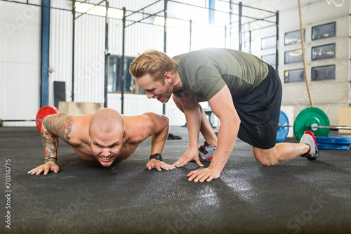 Trainer Motivating Man In Doing Pushups