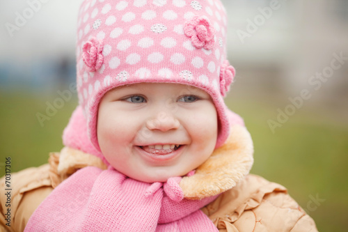 Cutel smiling little girl in pink coat close up  autumn photo