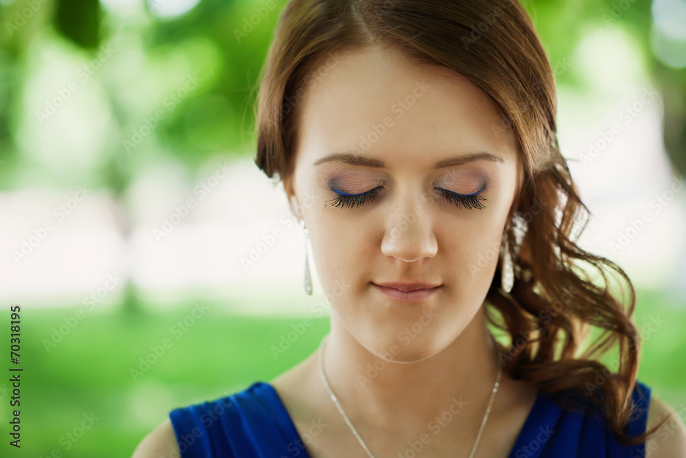 Portrait of beautiful young woman with eyes closed, against summ Portrait of beautiful young woman with eyes closed, against summ