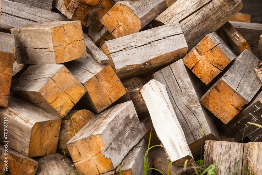 chaotic pile of firewood logs lying on green grass chaotic pile of firewood logs lying on green grass
