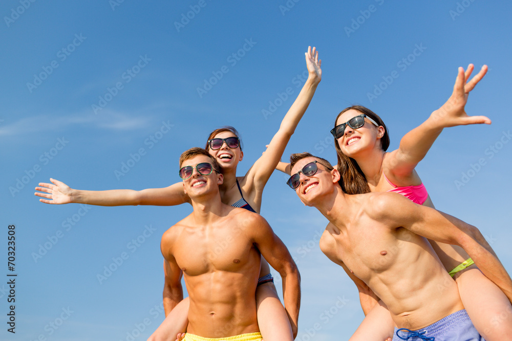 smiling friends having fun on summer beach smiling friends having fun on summer beach
