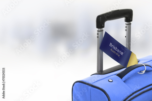 Brisbane, Australia. Blue suitcase with label at airport. photo