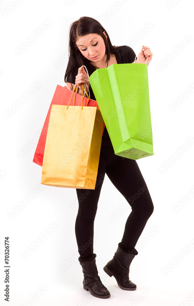 young woman with shopping bags isolated on white young woman with shopping bags isolated on white