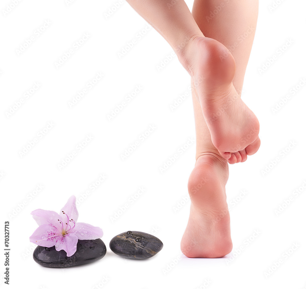 Female feet and Spa stones with spa flower