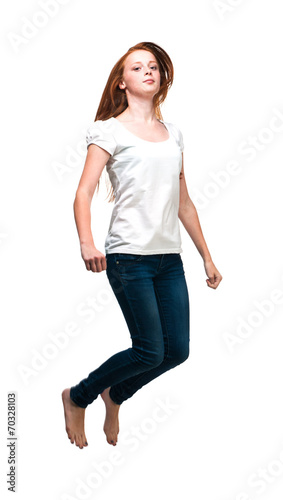 Jumping girl in a white T-shirt. Isolated on white background