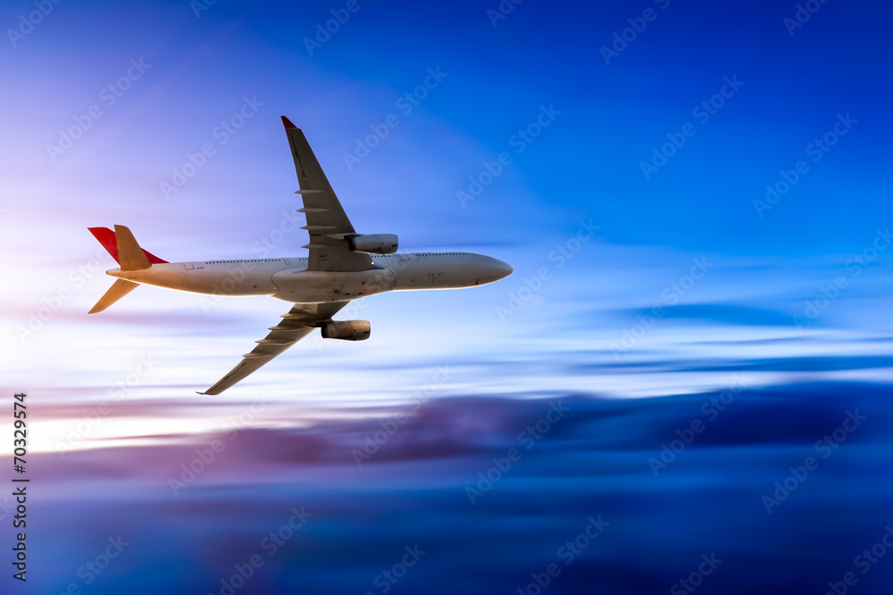Airplane in the sky at sunrise Airplane in the sky at sunrise