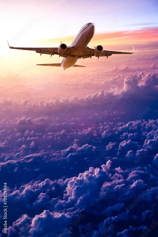 Airplane in the sky at sunrise Airplane in the sky at sunrise