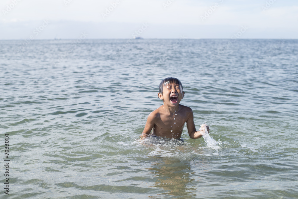Children playing and diving in the ocean