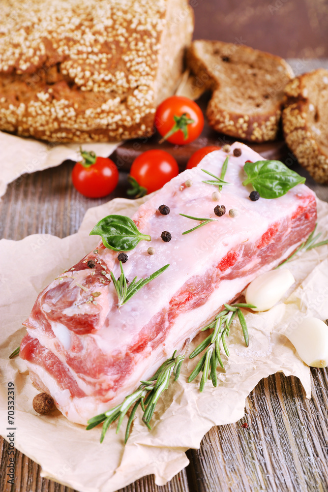 raw bacon with bread and spices on wooden table raw bacon with bread and spices on wooden table