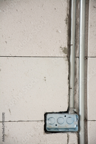 electric system on wall  in construction site  ,outlet with iron © Suwatchai
