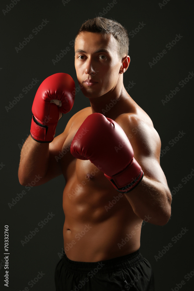 Handsome young muscular sportsman with boxing gloves Handsome young muscular sportsman with boxing gloves