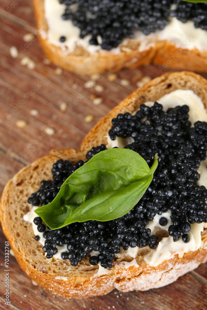 Slices of bread with butter and black caviar Slices of bread with butter and black caviar