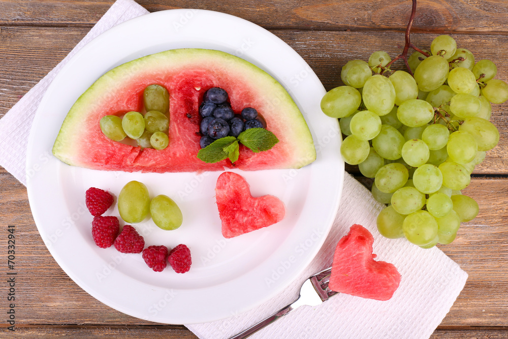 Fresh juicy watermelon slice with cut out heart shape, filled Fresh juicy watermelon slice with cut out heart shape, filled