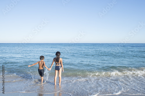 Siblings you are holding hands at beach