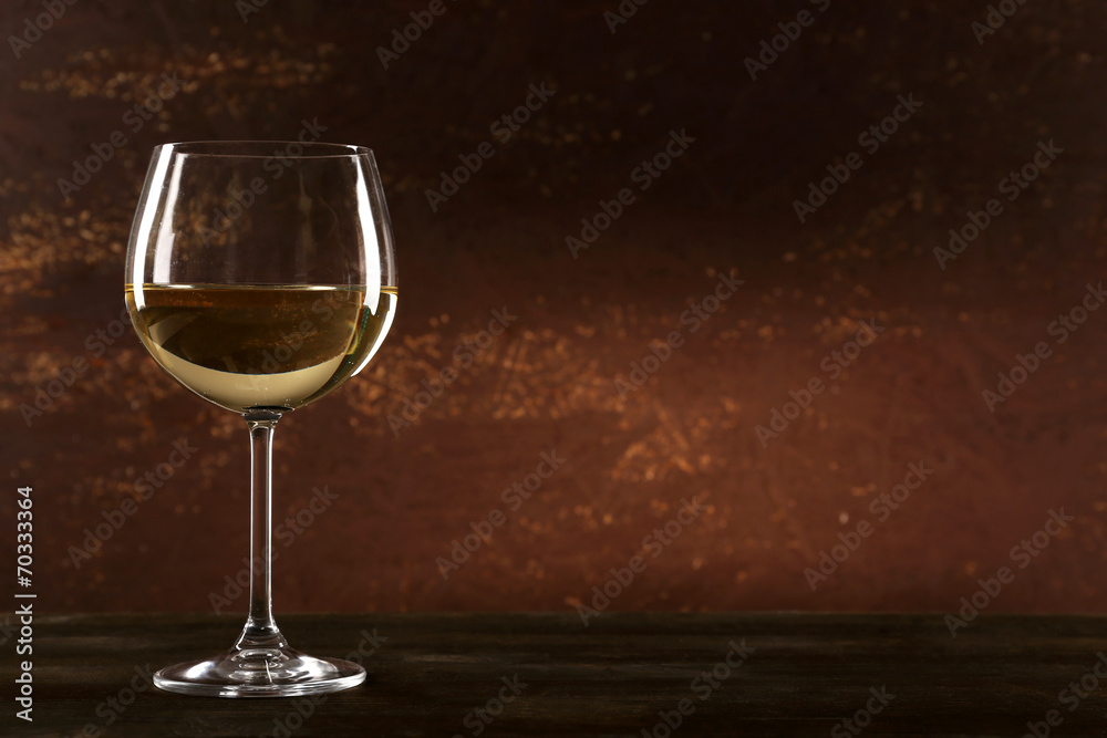 Goblet of white wine on wooden table on wooden wall background Goblet of white wine on wooden table on wooden wall background